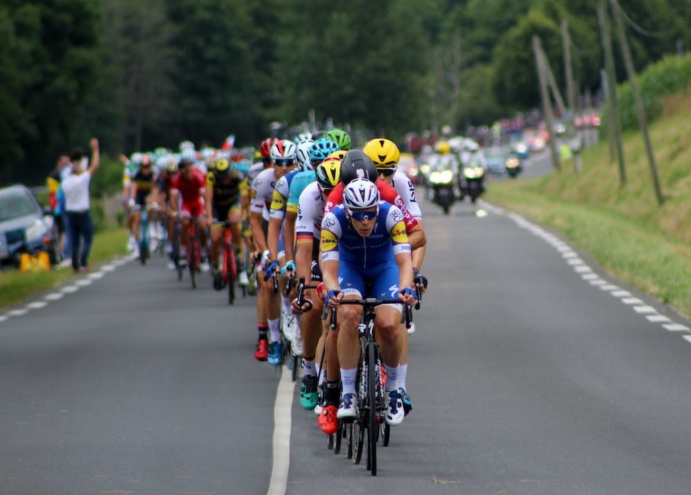 group of cyclists marching on highway